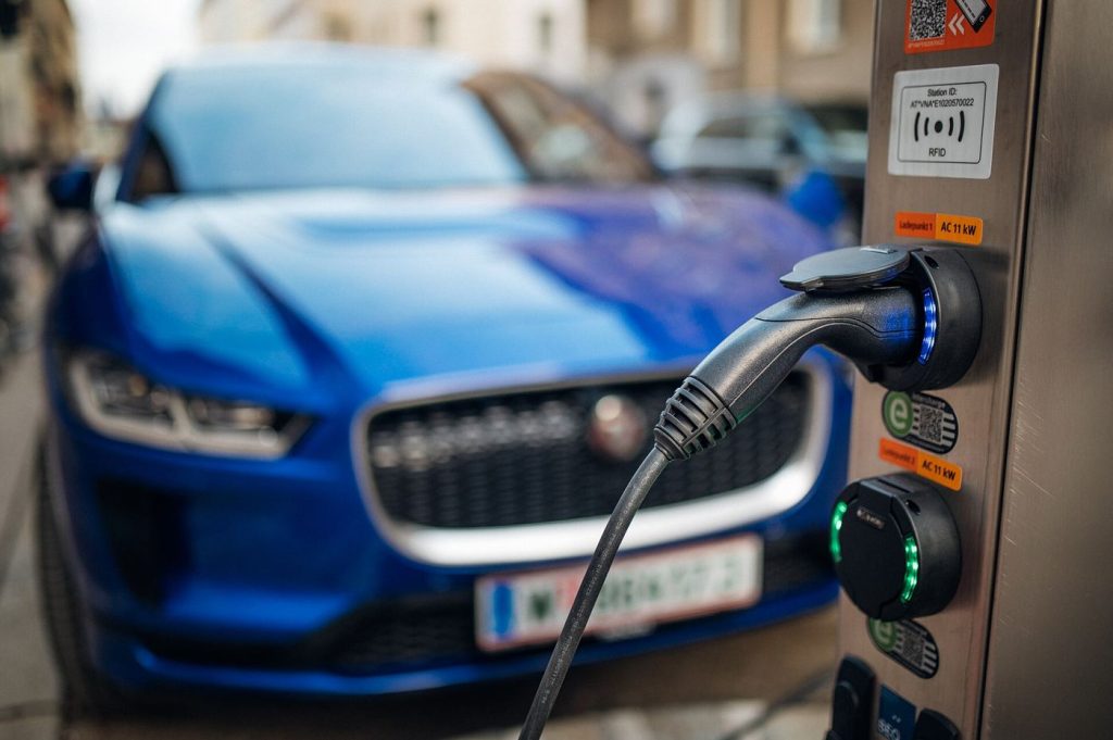 Solid-State Batteries Promise Longer EV Range by 2027 An electric car plugged into a charging station